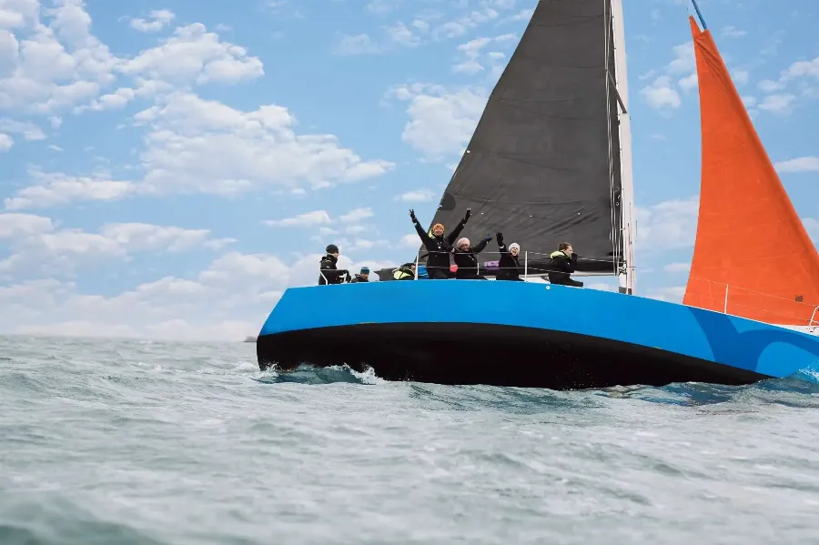 excited people on a sailing boat